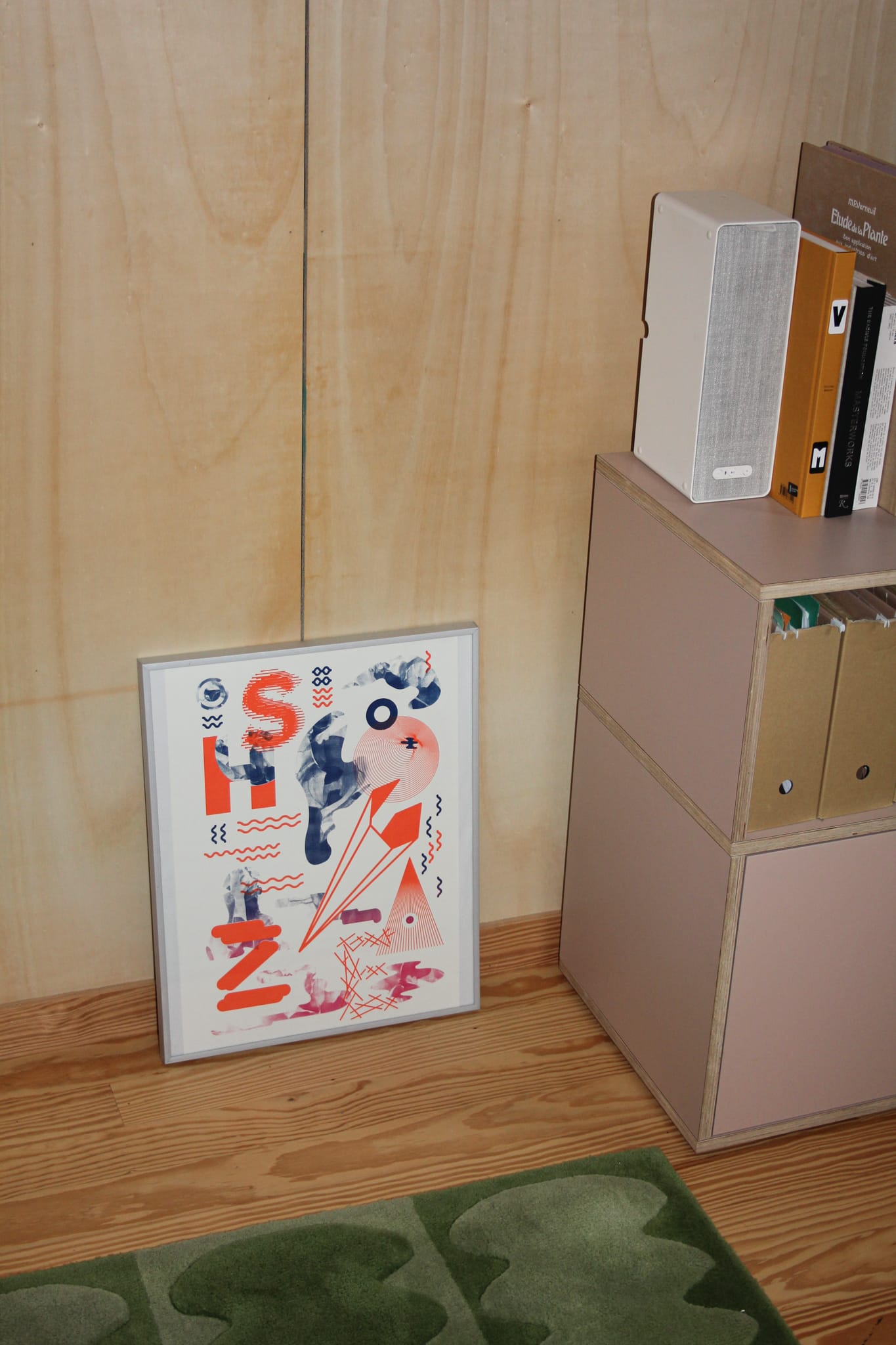 Photo of art frame next to a furniture.